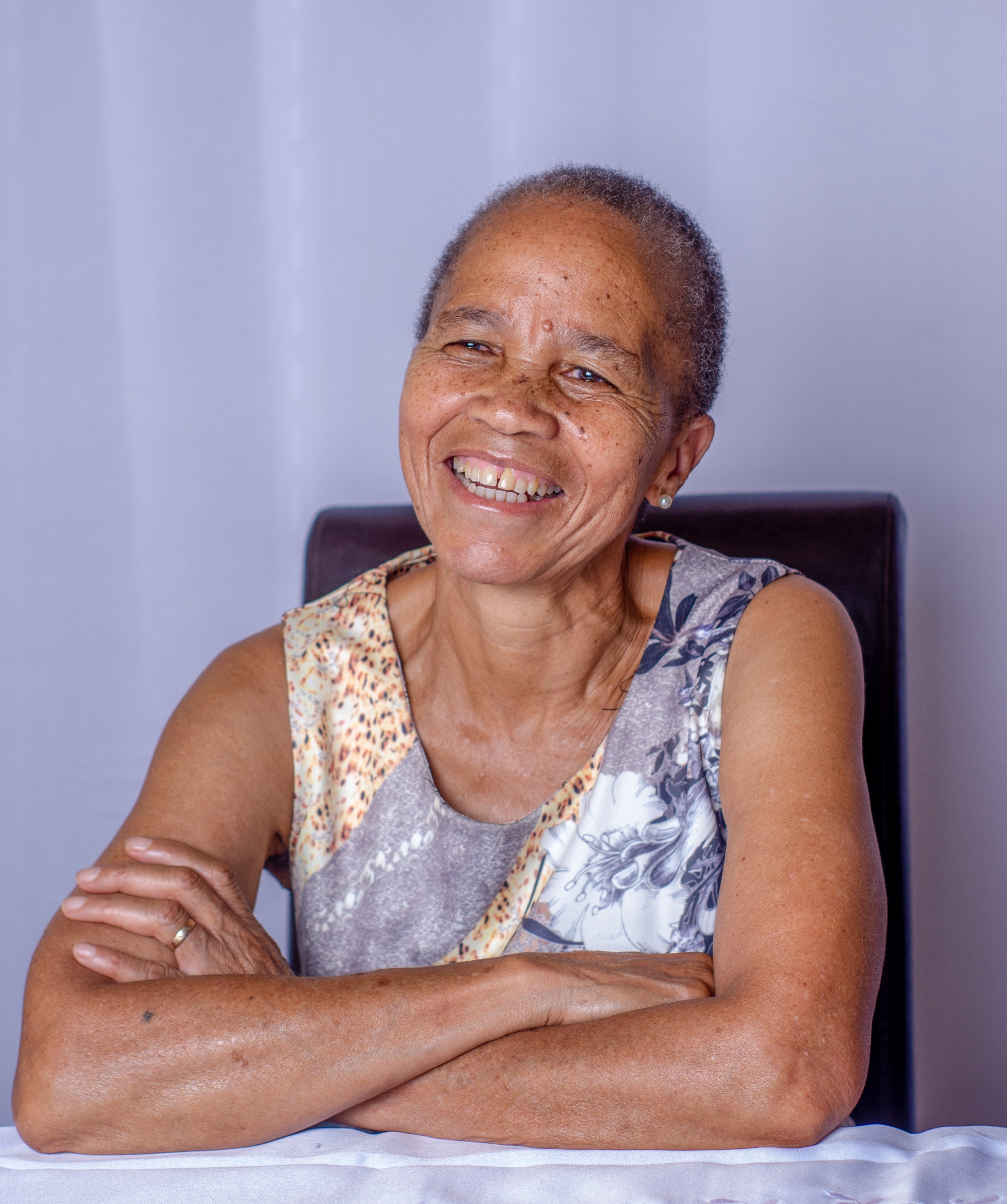Elderly woman sitting on chair and smiling
